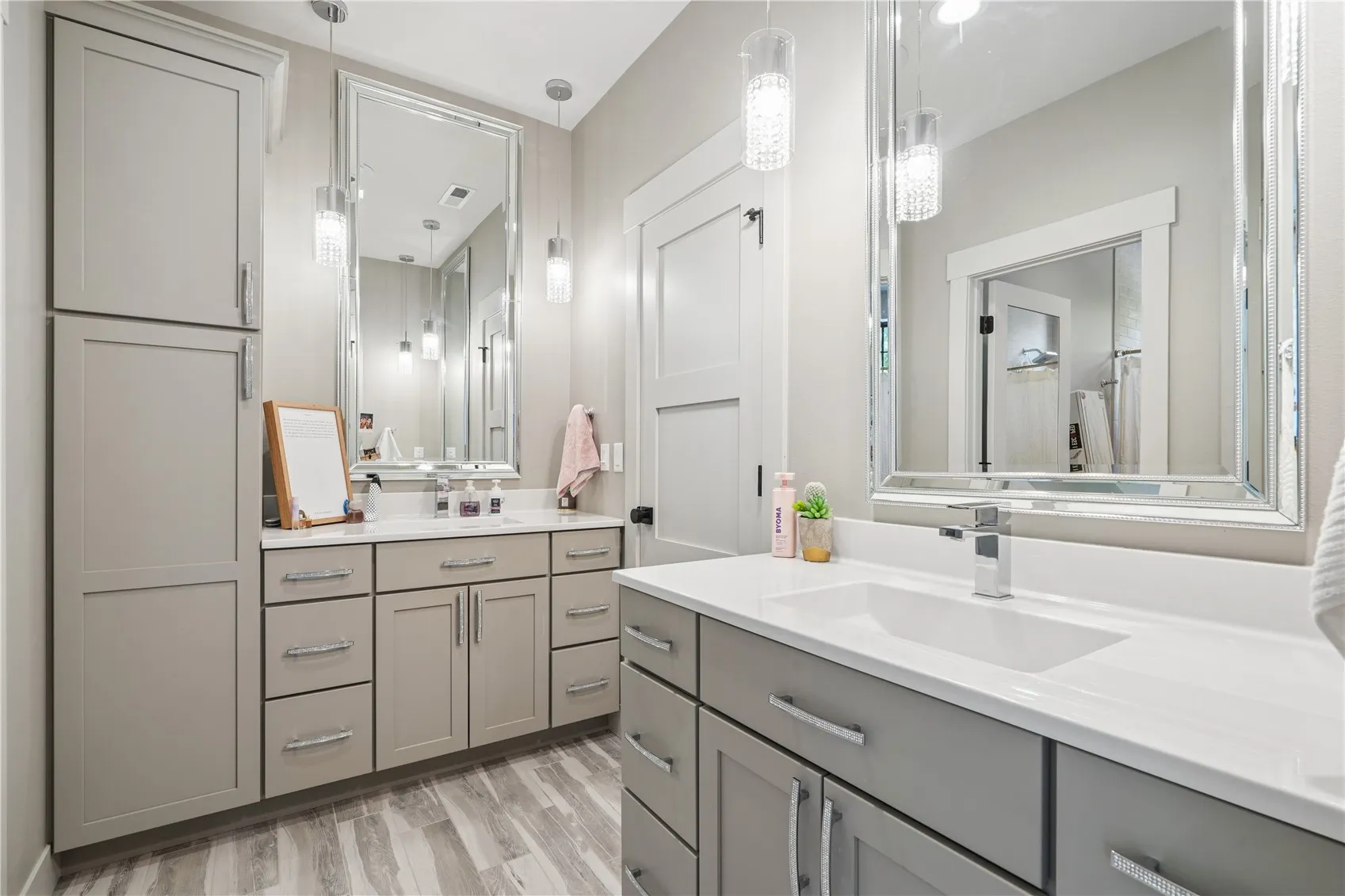 Jack and Jill bath with 2 separate sinks and a linen c.abinet.