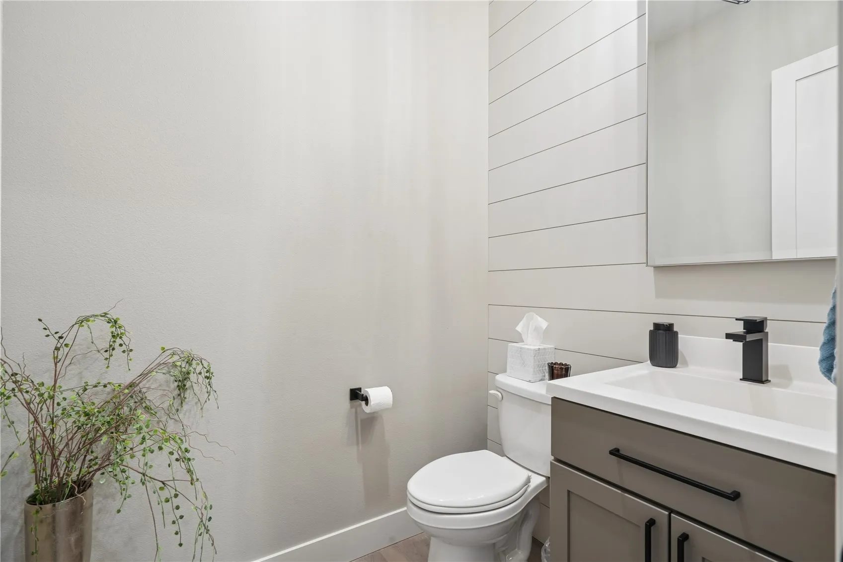 The main level guest half bath is of generous size.