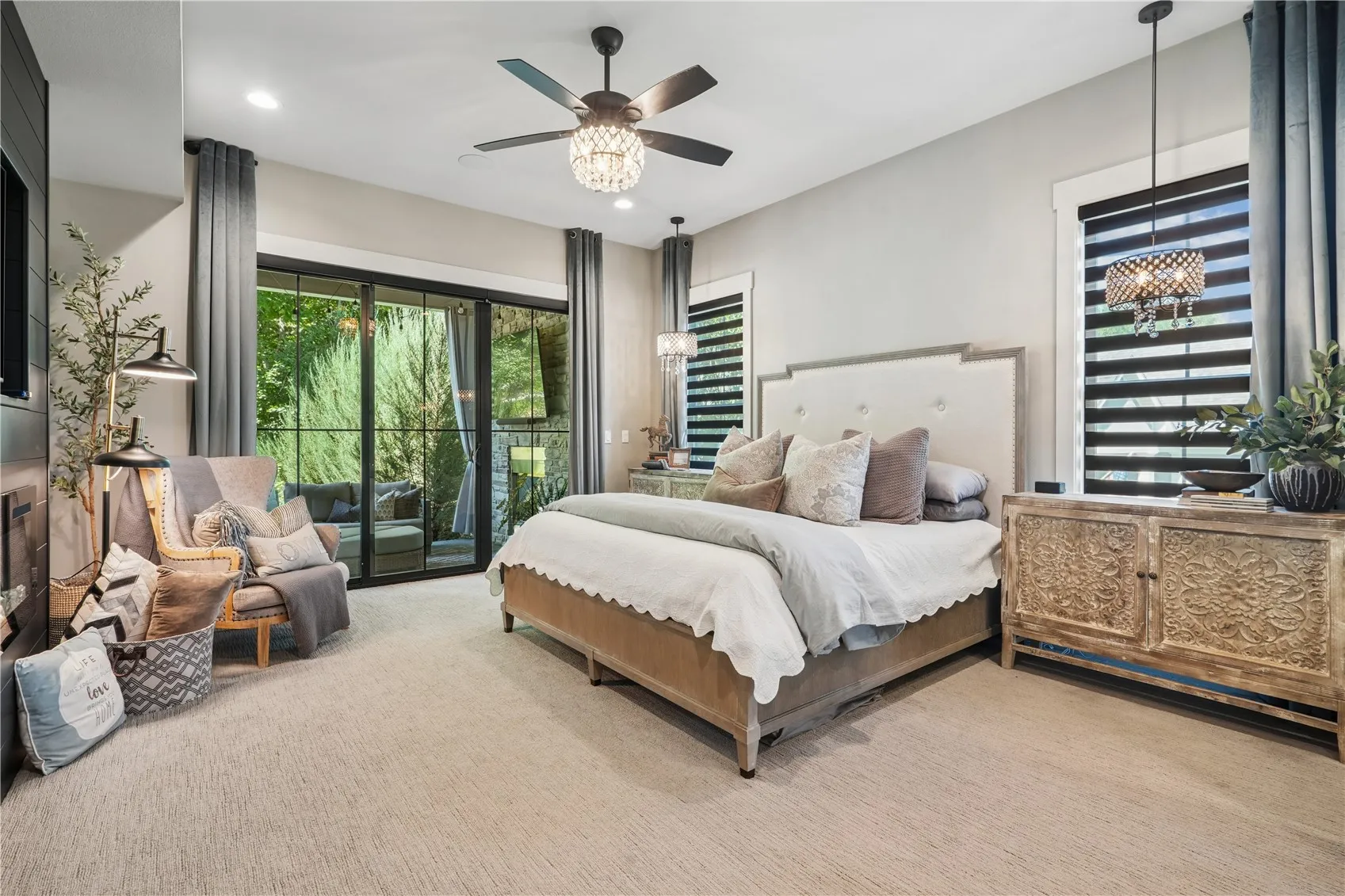Spacious Primary Bedroom with slider to the covered back porch and motorized custom blinds.