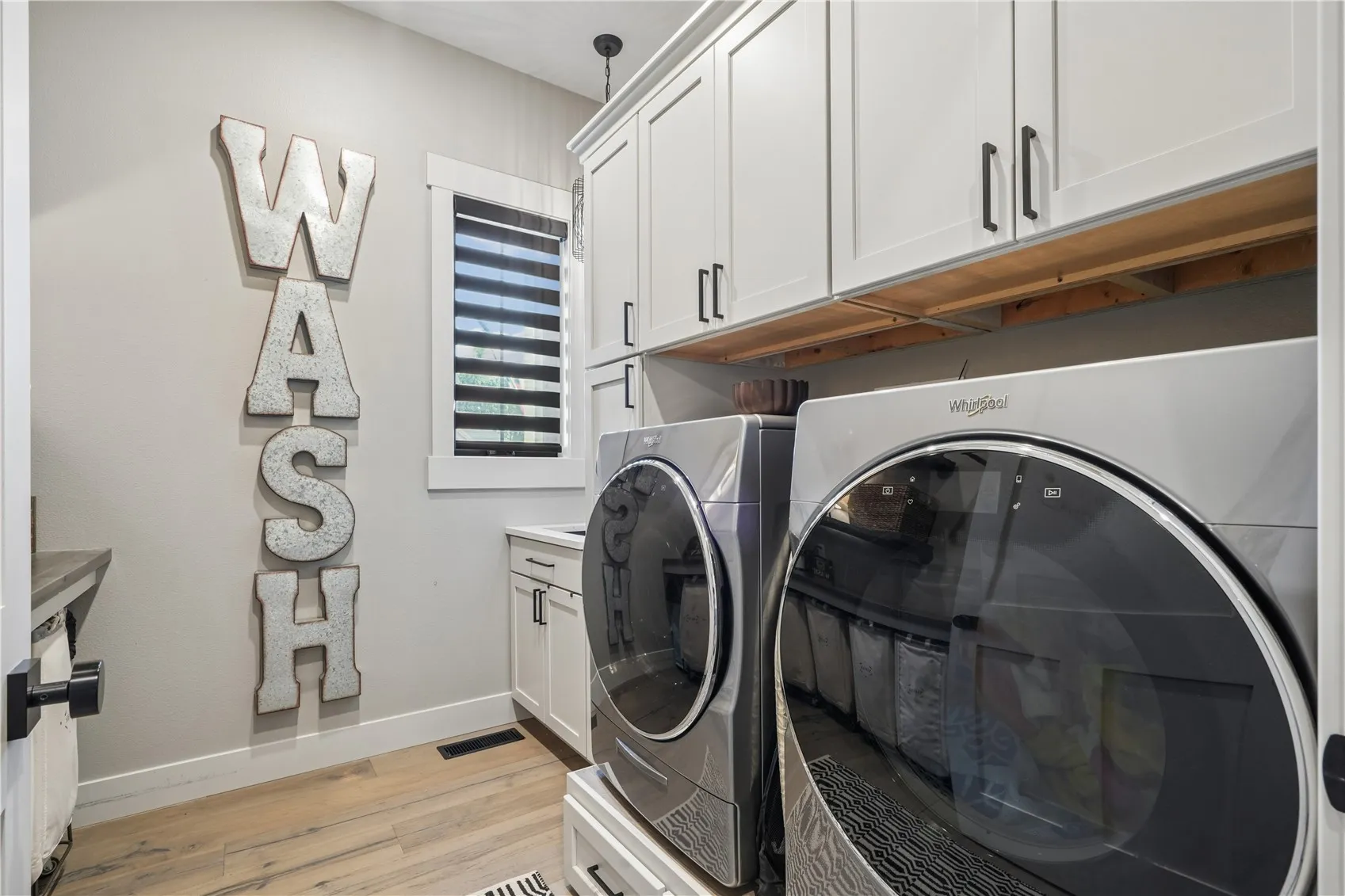 Main floor laundry conveniently situated near the Primary Bedroom and the Living/Great Room.