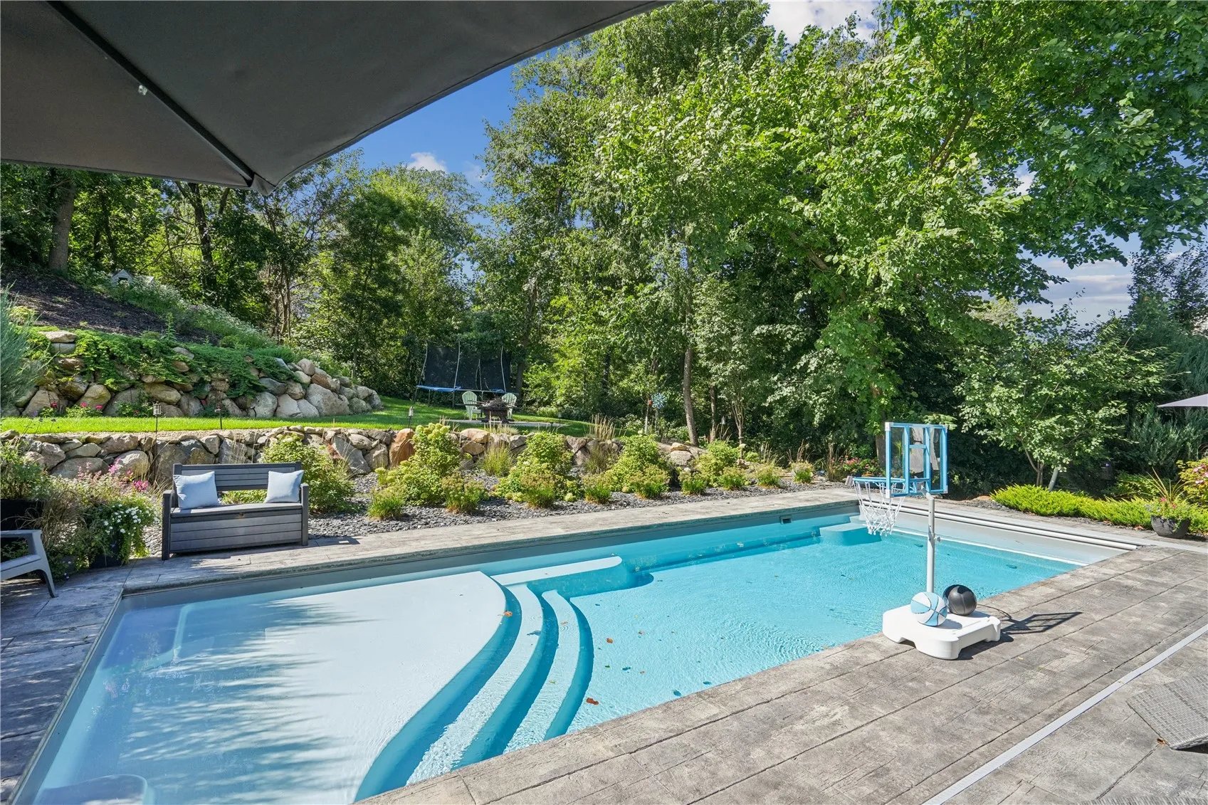 14x35 Fiberglass saltwater pool with stamped concrete and powered safety cover is the final highlight of this incredible home.