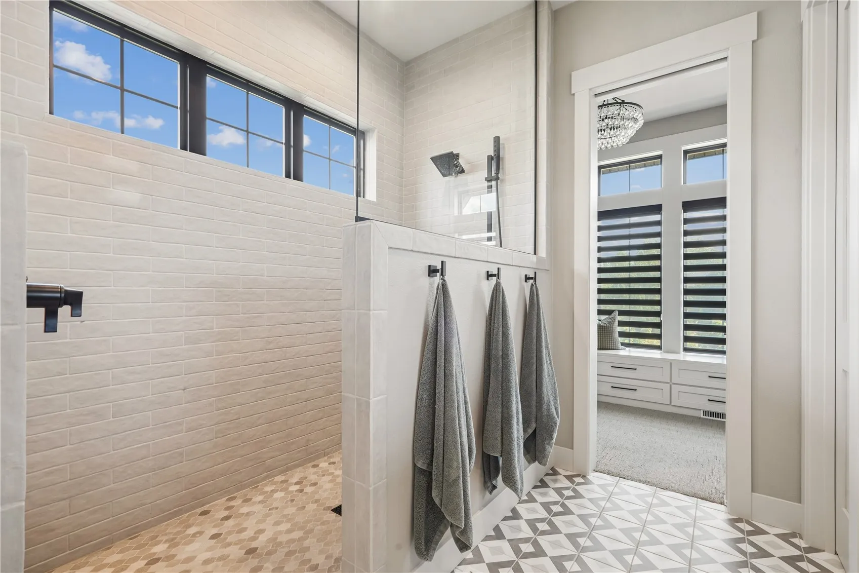 Primary bath features a tile and glass shower.