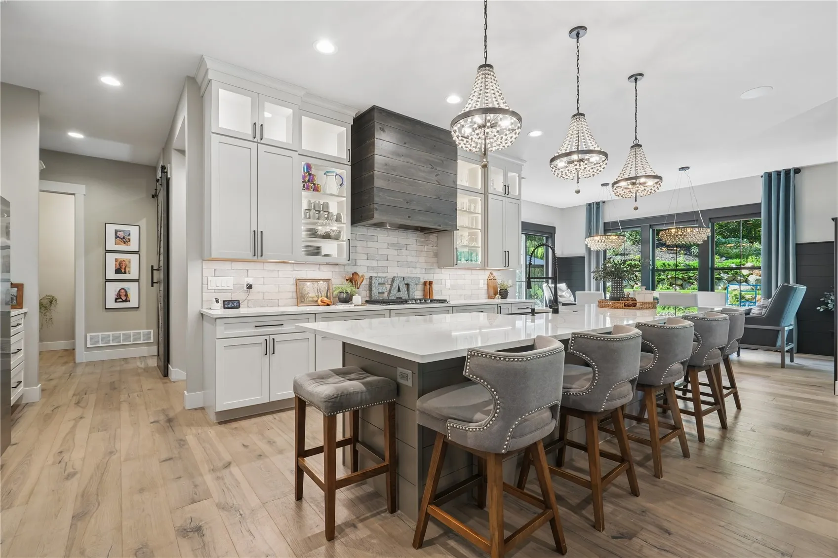 Custom hood, tile backsplash and lighted cabinetry add so much to this most grand kitchen.