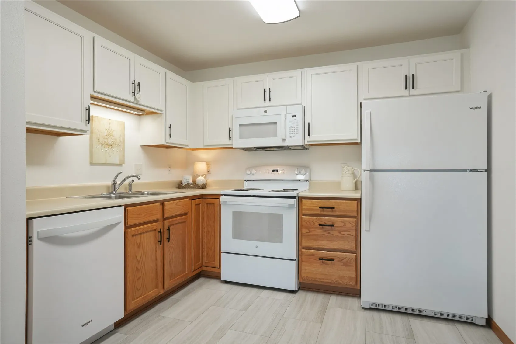 New upper cabinets, garbage disposal, refrigerator, diswasher, and flooring