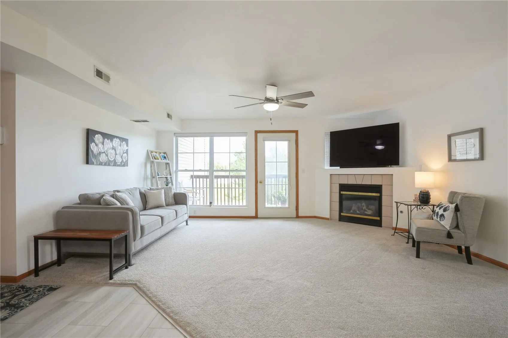 Large well lit living room with new ceiling fan