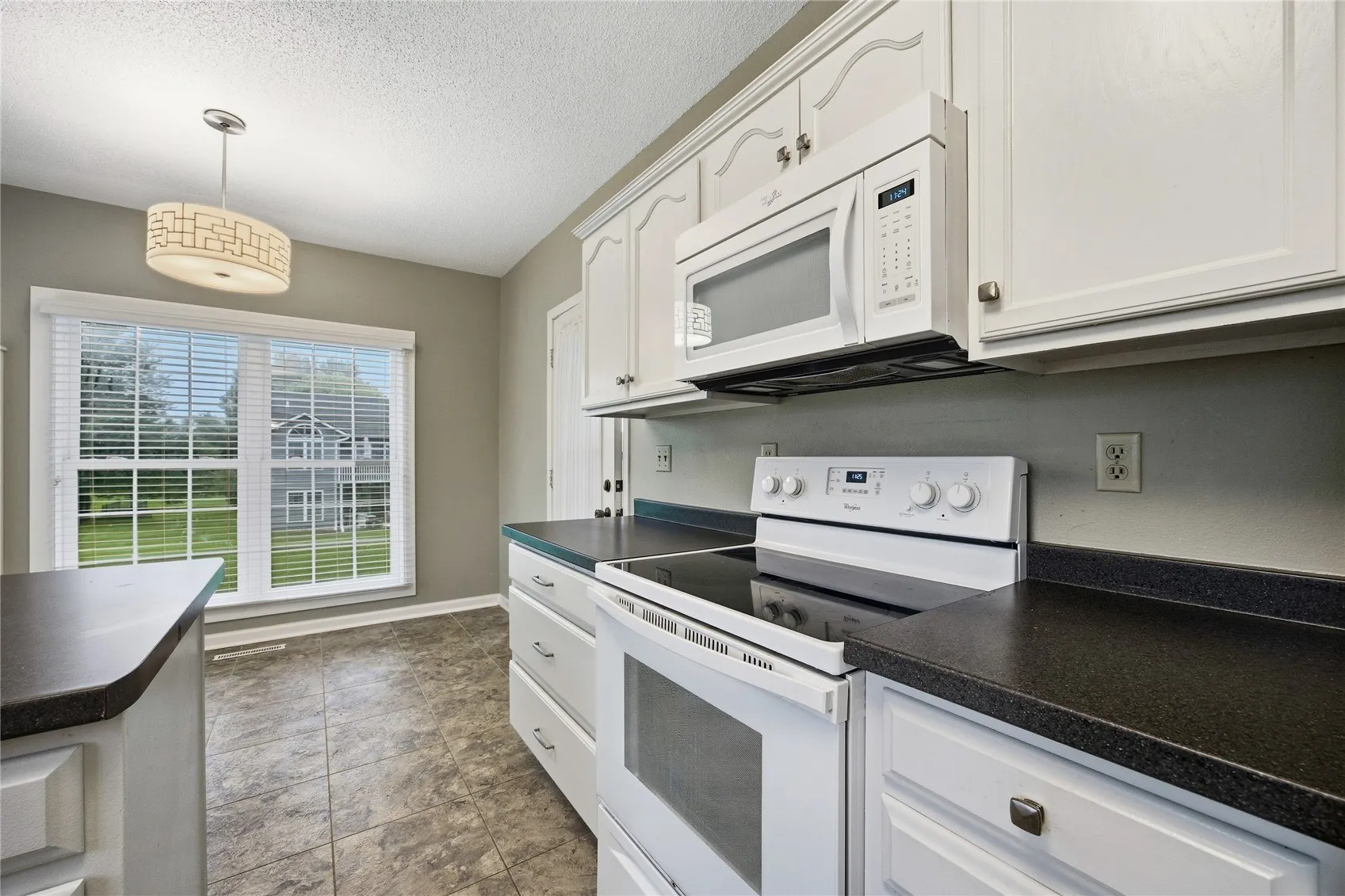 Electric stove and microwave stay. Plenty of counter space.
