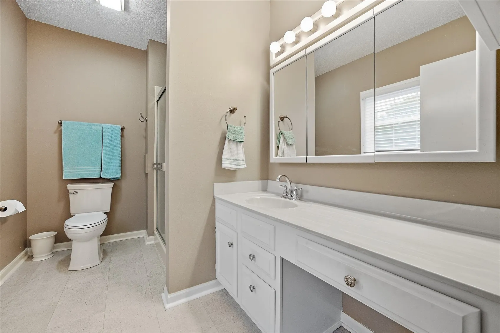 Can you say counter space and room to spare. The primary bathroom area also has a new tile floor.