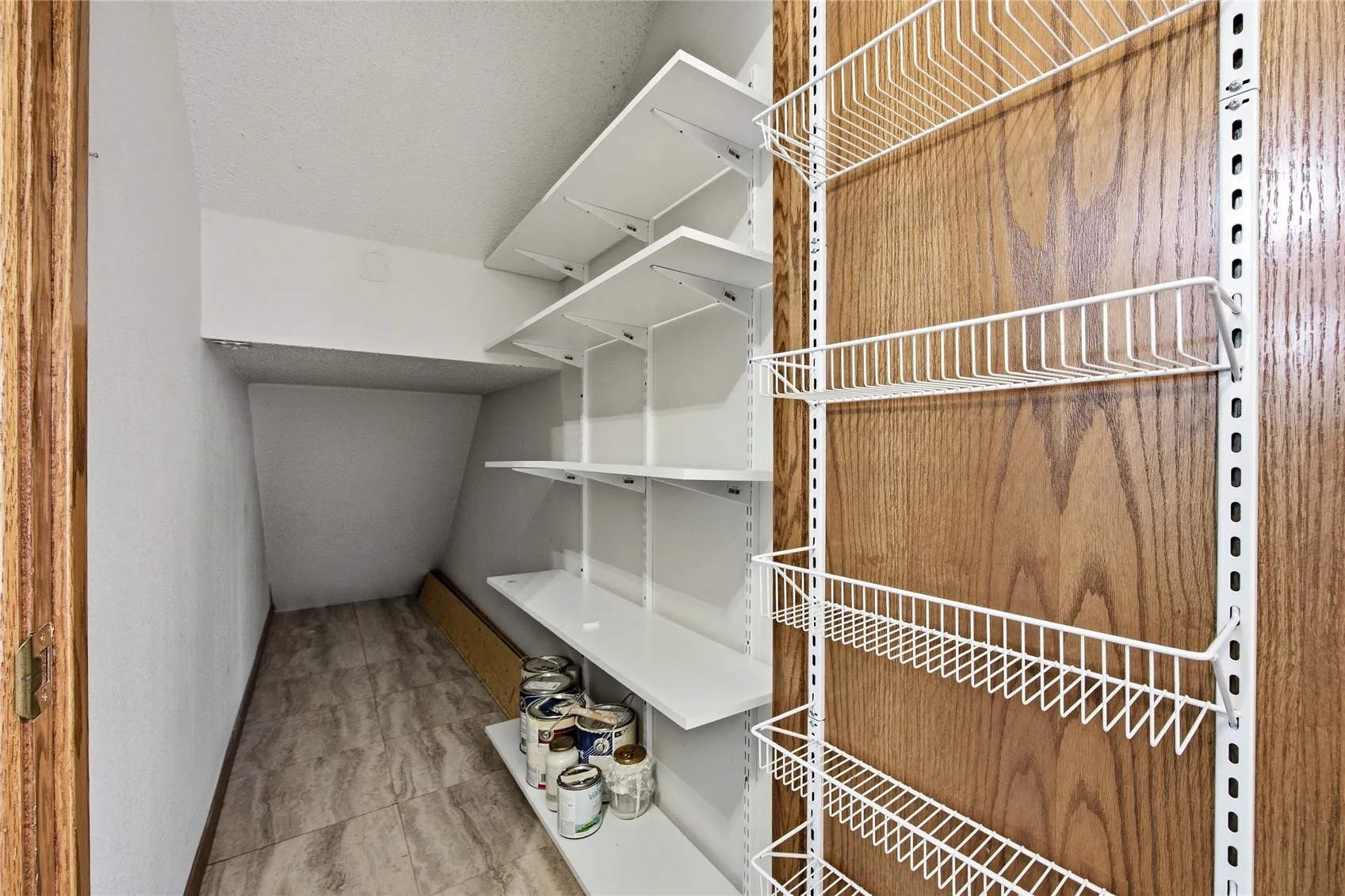 This is the Unit B Storage area. It is located just outside of the main entrance to Unit B. There is a key to lock this door. Yes, the shelving stays as does the racks on the inside of the door.
