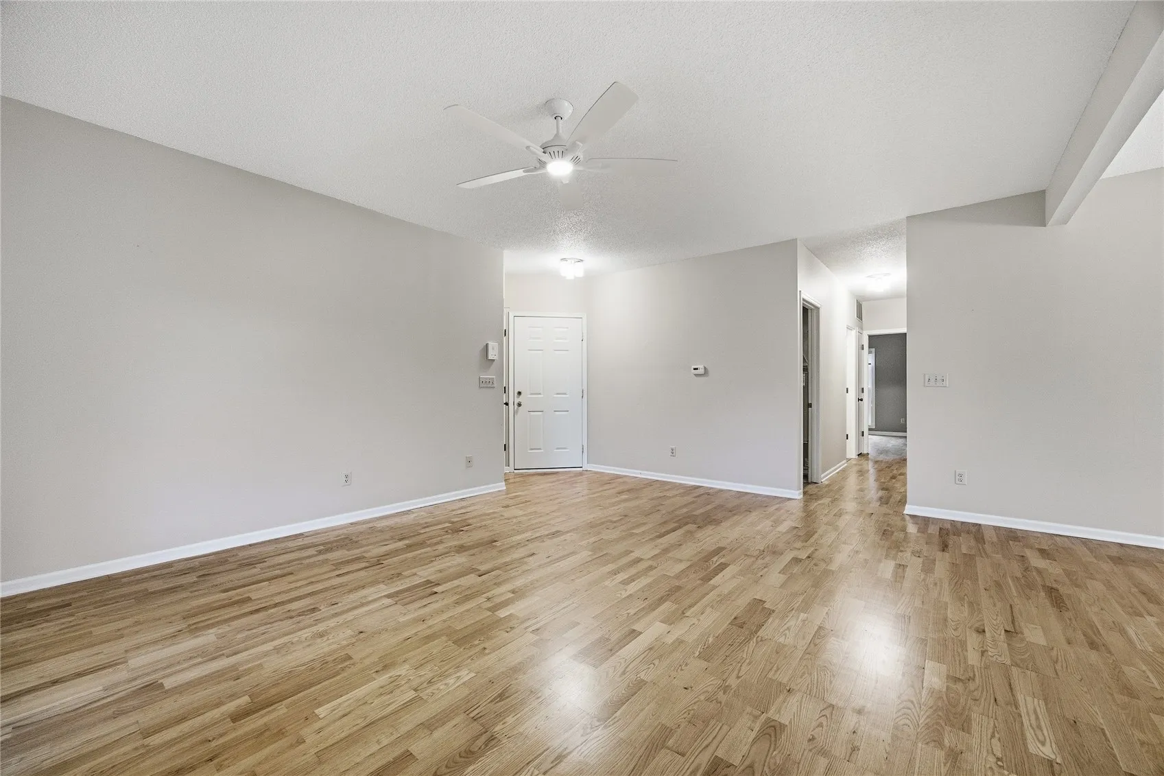 Wood flooring extends down the hallway.