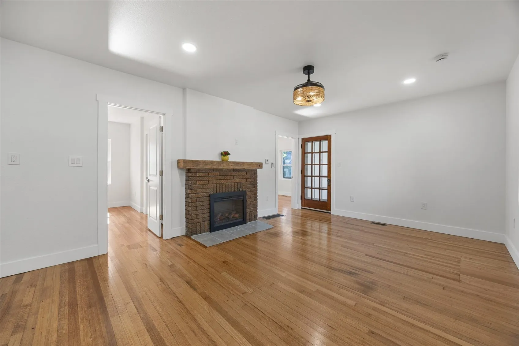 View of front corner of living room with 1st bedroom to the left