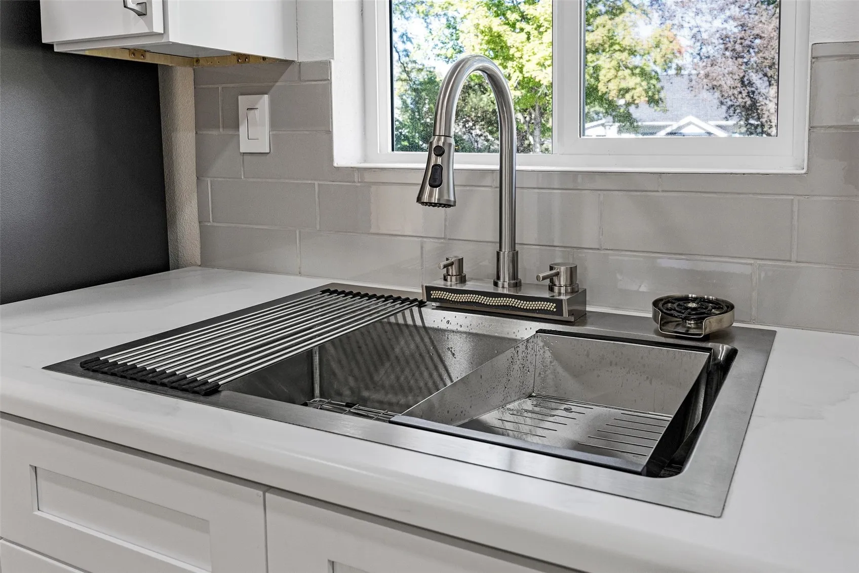 Sink includes waterfall feature and cup washer