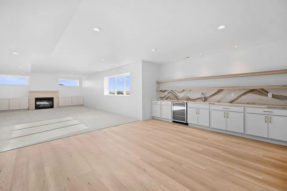 lower level rec area w/ wet bar, beverage fridge and storage cabinets and family room. Great for play or home school room