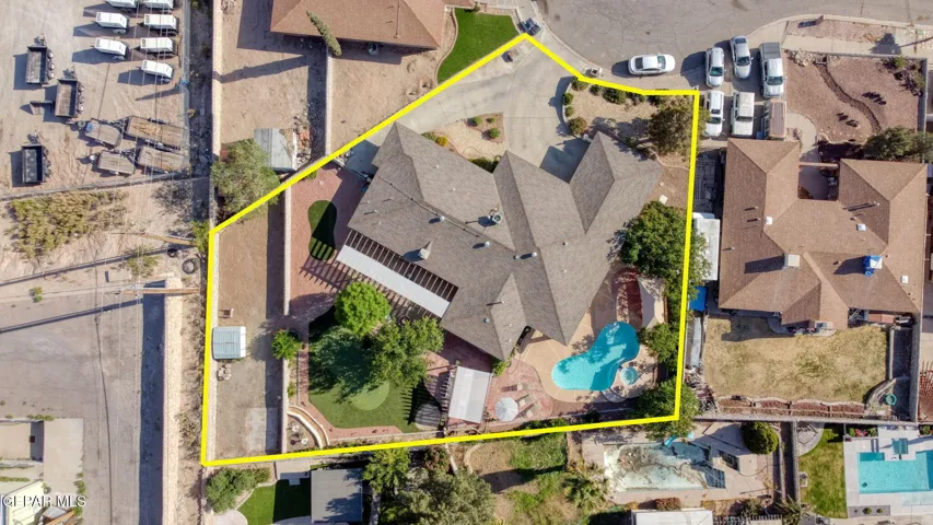 Back yard wraps all around, Pool/Jacuzzi,putting green, pergola, covered patio with kitchen windows and French doors to back, RV parjubg