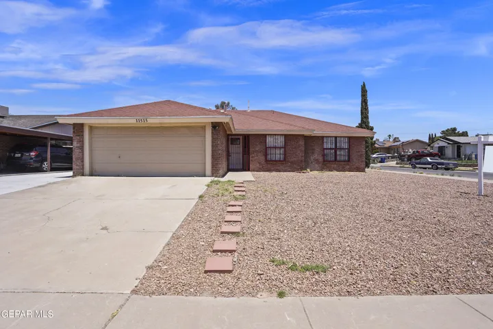 Extended driveway, perfect for additional parking, RV parking and so much more. You can also pull the car or RV through wrought iron gates for extra security