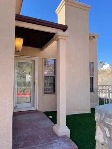 Entrance to home with covered pergola