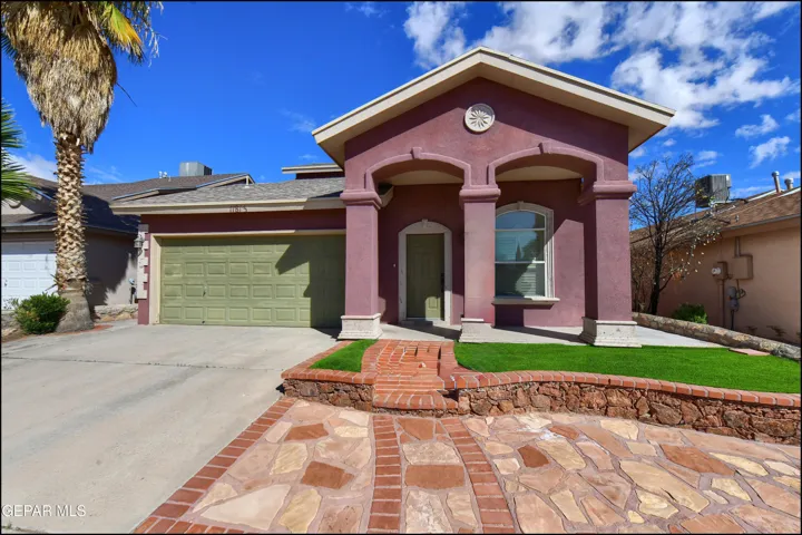 Stucco exterior with an arched entry and accent columns