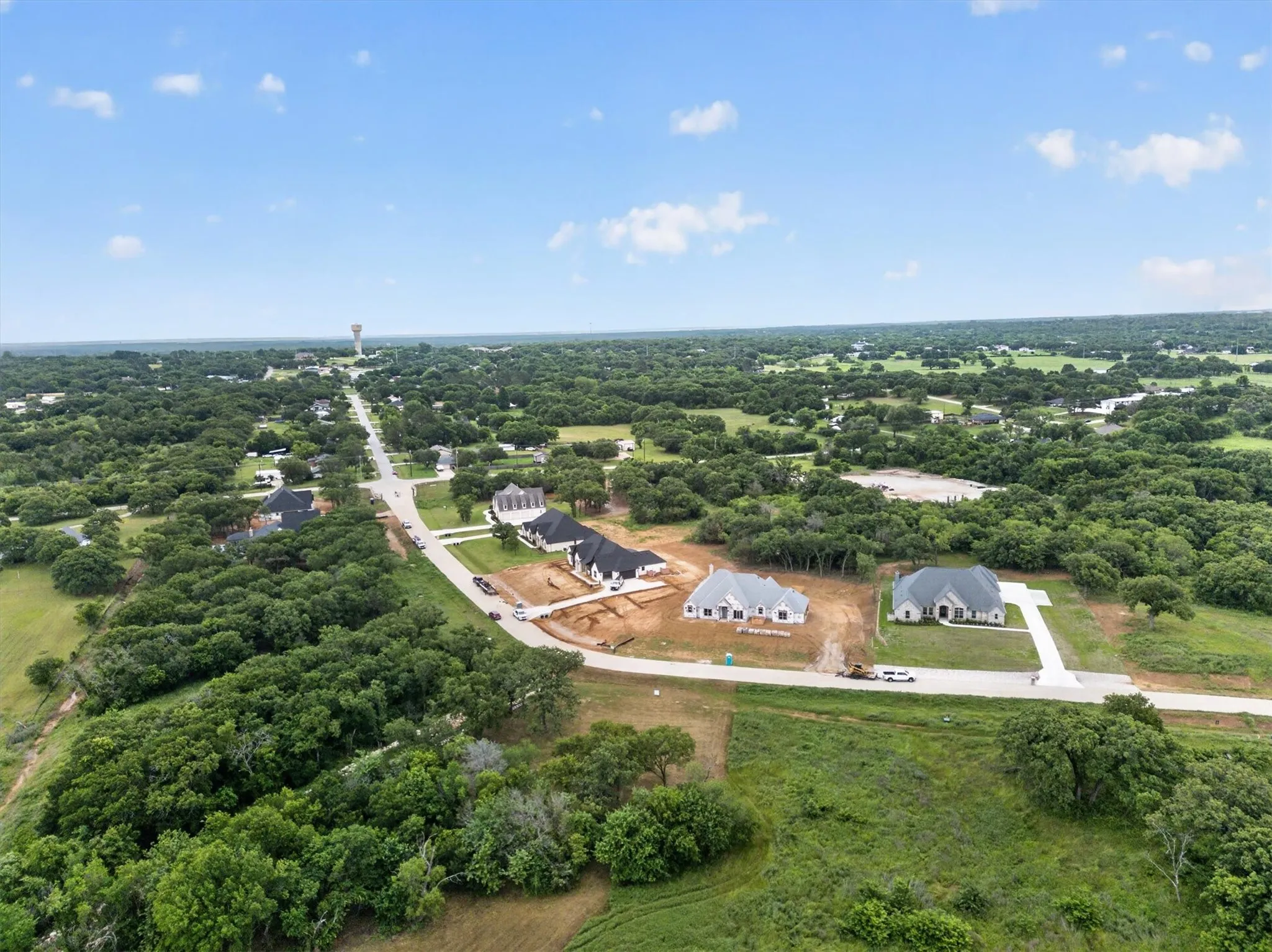 Aerial perspective showcasing new construction properties amidst a verdant landscape