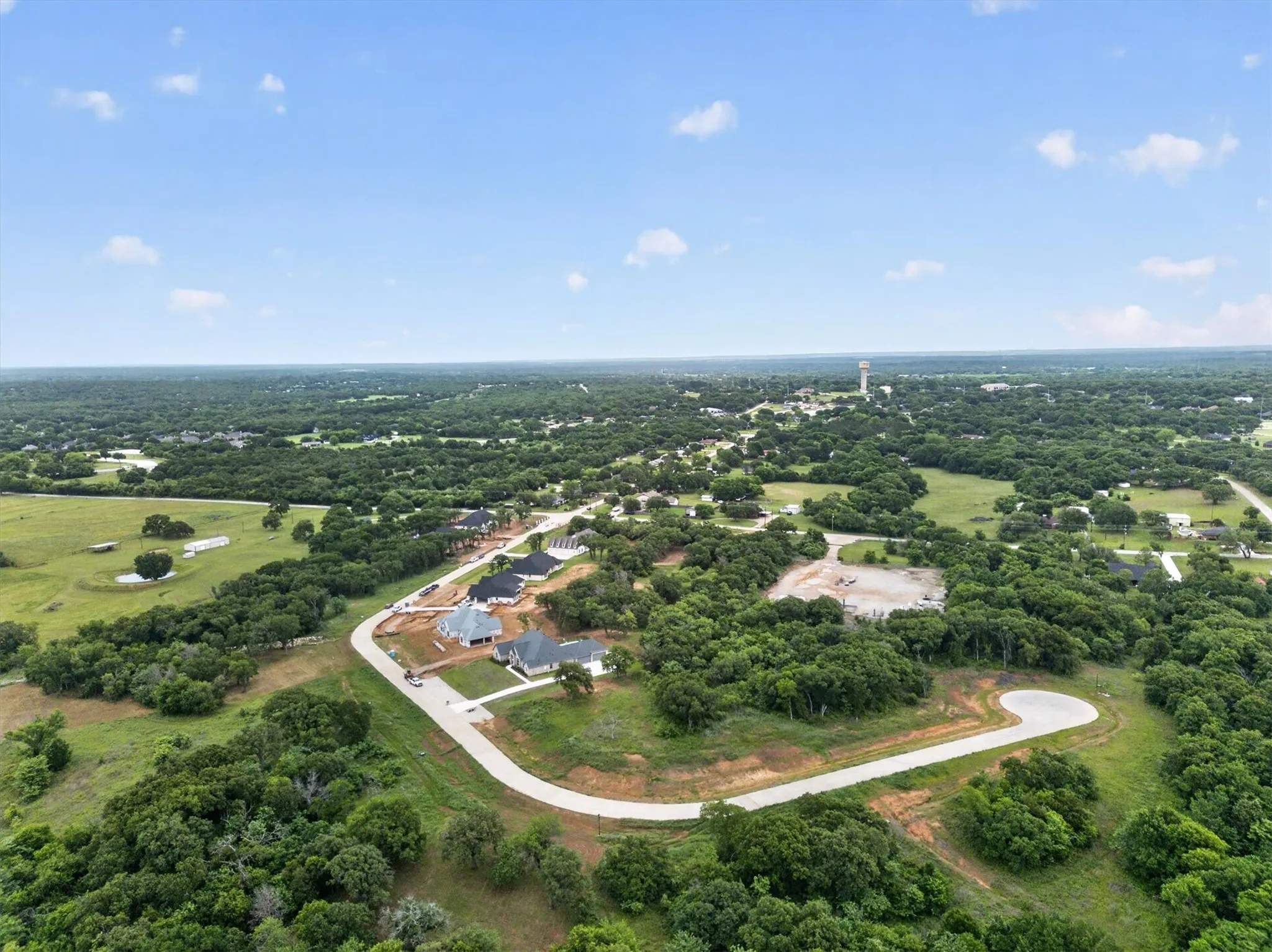 Expansive aerial perspective showcasing a developing residential area with multiple properties under construction