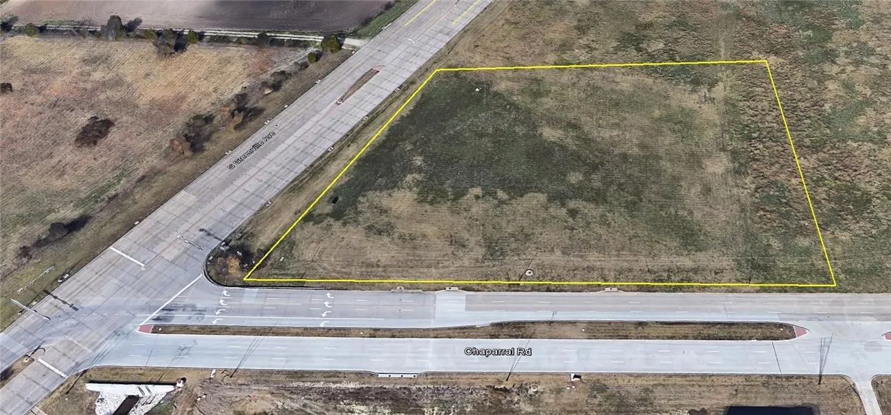 NE hard corner of Greenville and Chaparral in Allen. To the west across Greenville is flood plane and the nature preserve. Across Chaparral is City of Plano property.