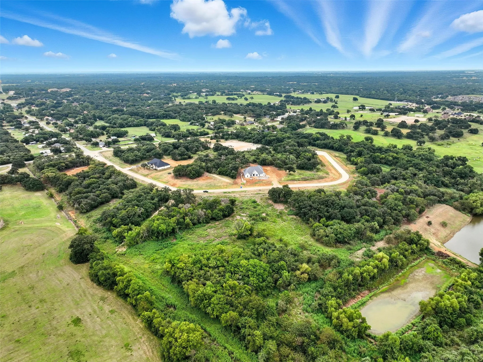 View of property location with a tree filled landscape