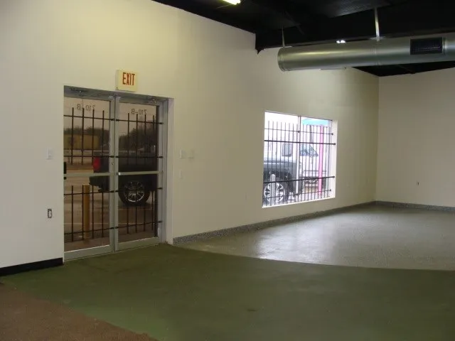 Enter into open area with one office.  Concrete painted flooring.