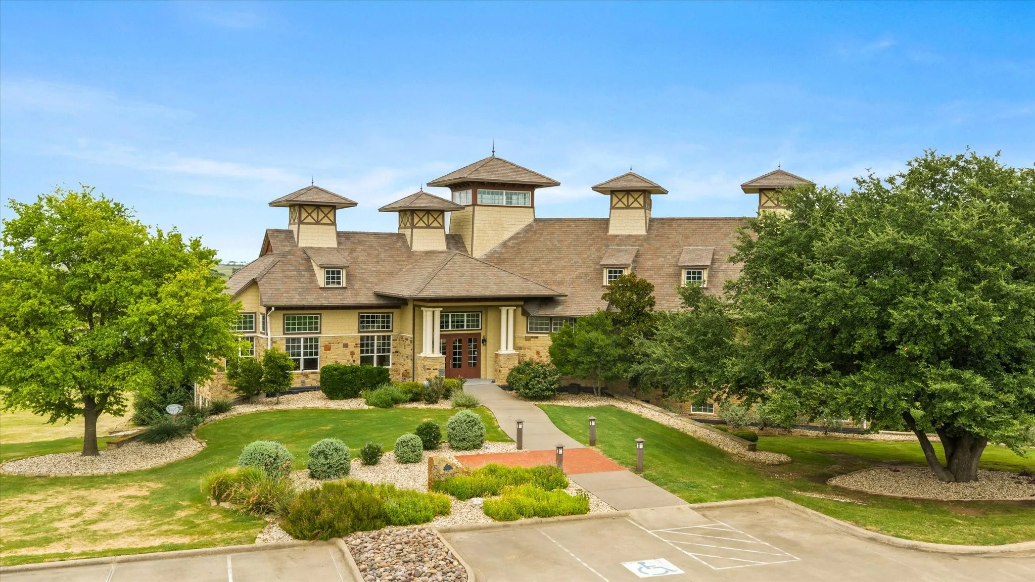 Stone and stucco exterior building featuring multiple dormer windows