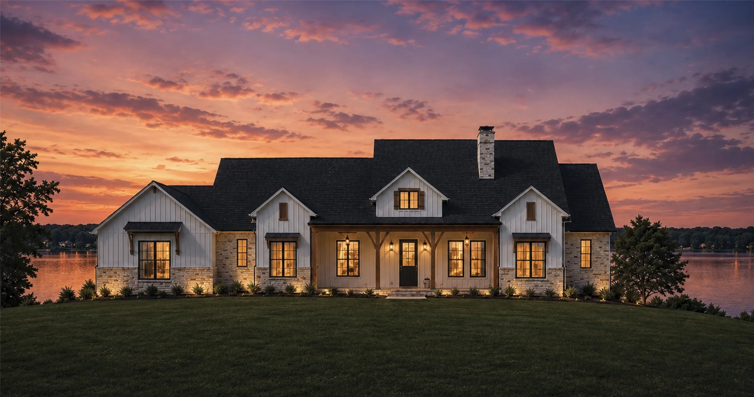 Front Elevation Twilight Rendering. Modern farmhouse exterior featuring stone and vertical siding