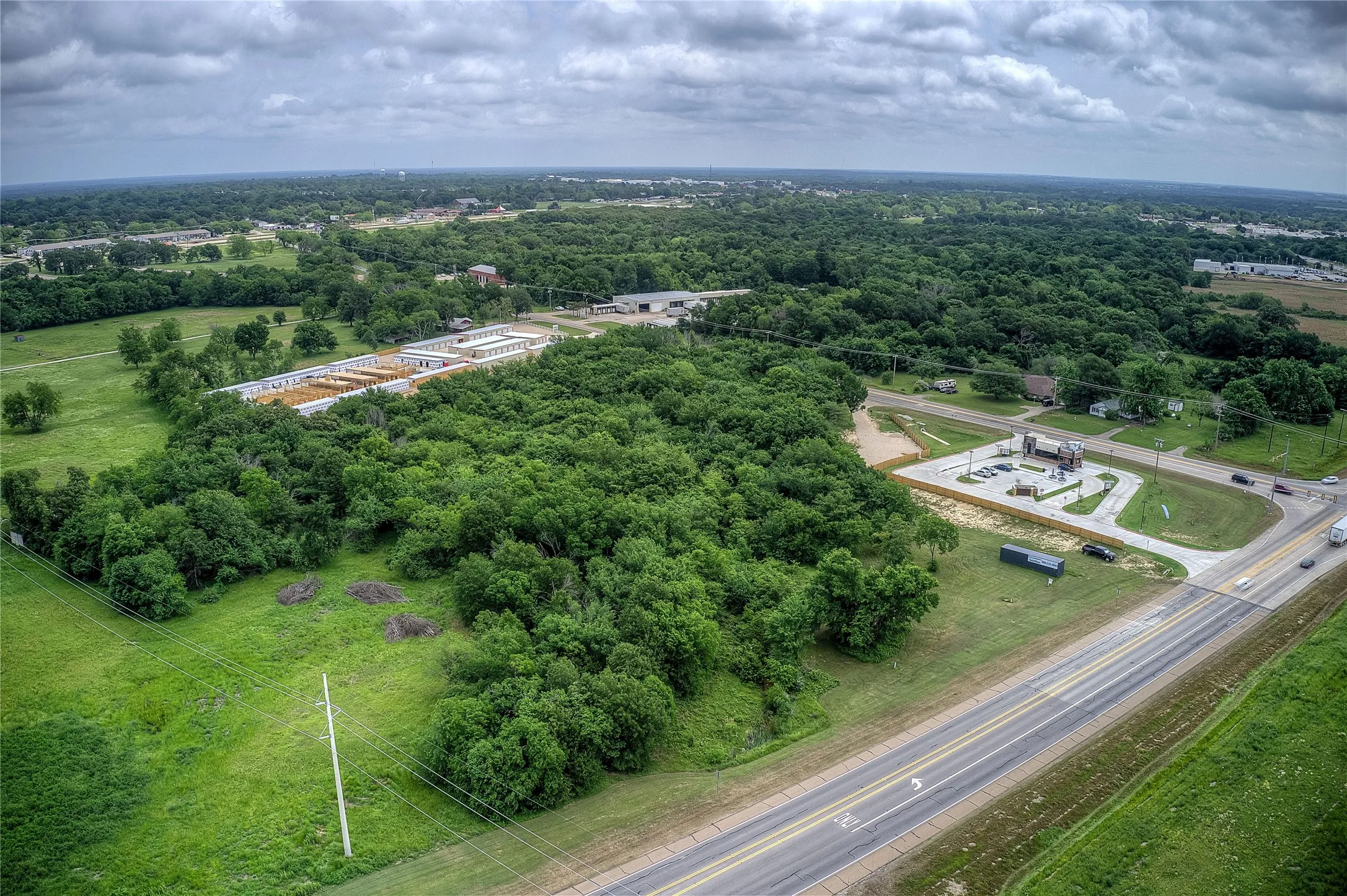 Birds eye view of property with a forest view