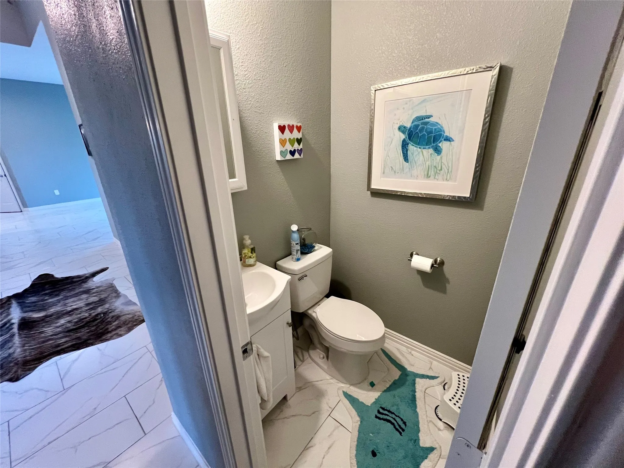 Bathroom featuring vanity, toilet, and tile floors