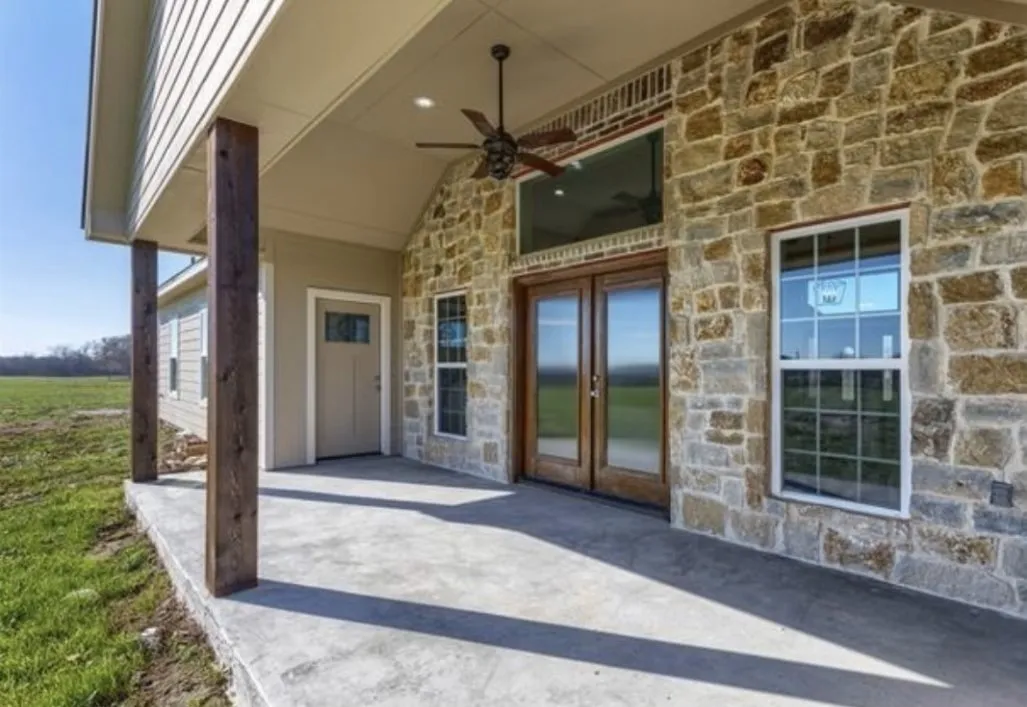 View of patio with french doors and ceiling fan