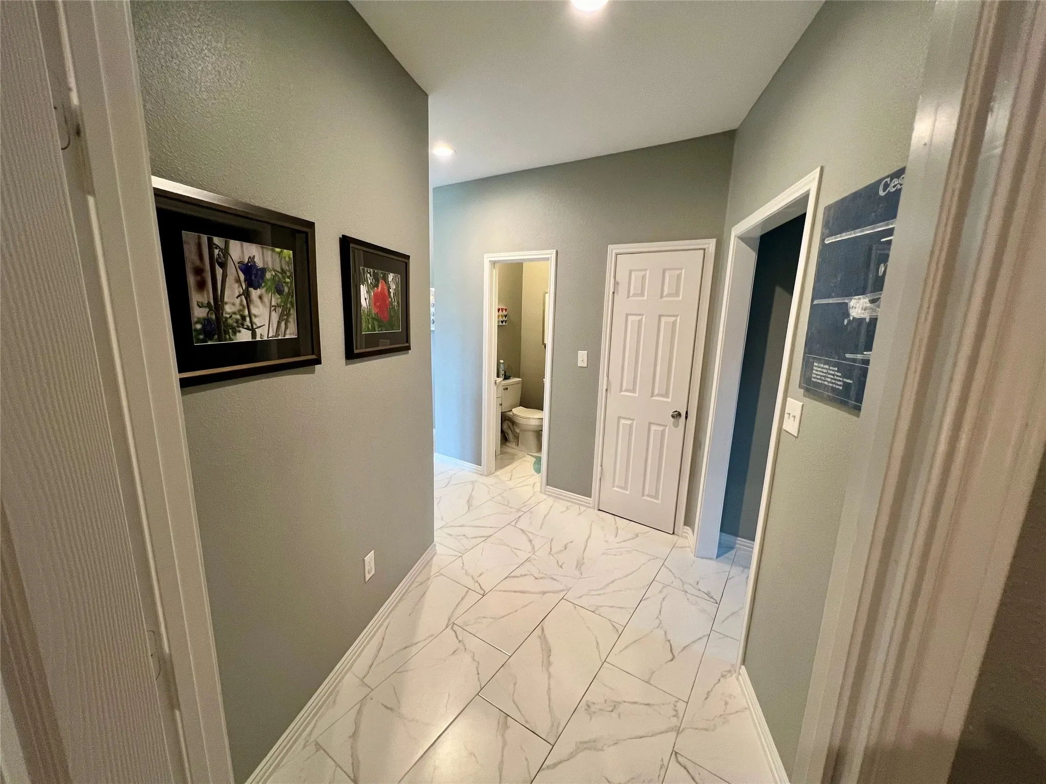 Hallway featuring light tile flooring