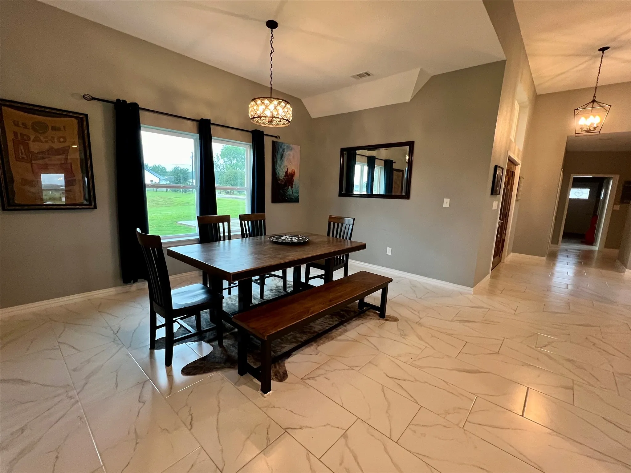 Tiled dining room featuring a notable chandelier