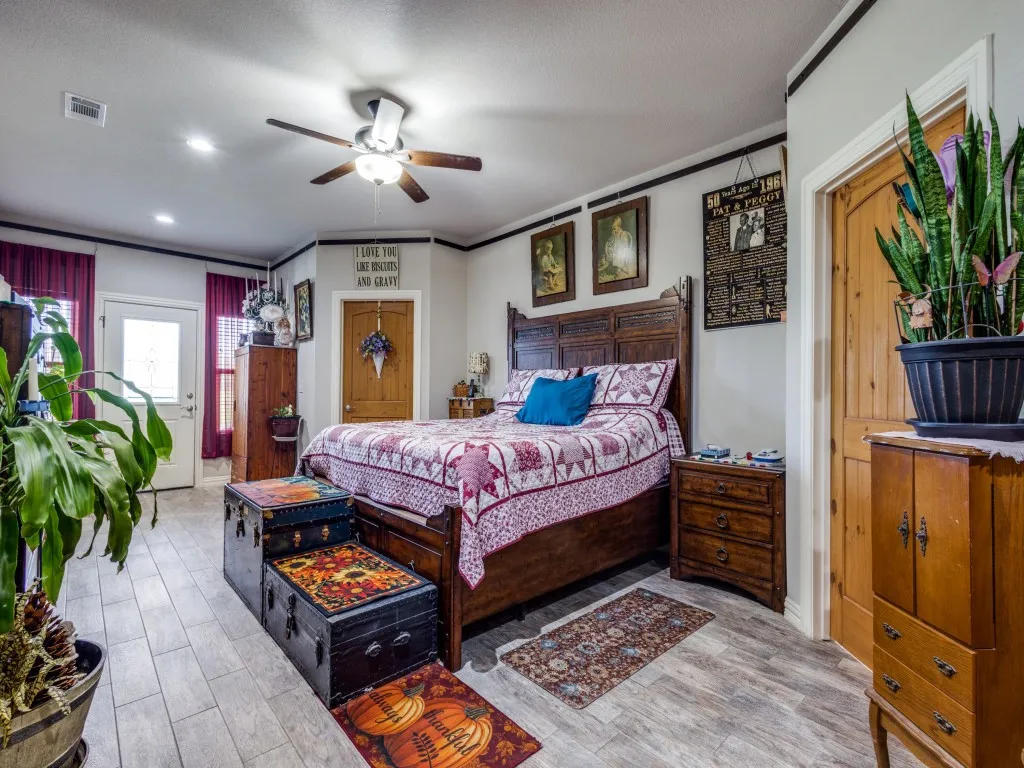 Bedroom featuring light hardwood / wood-style floors and ceiling fan