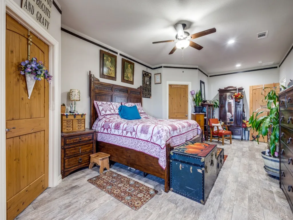 Bedroom with light hardwood / wood-style flooring and ceiling fan