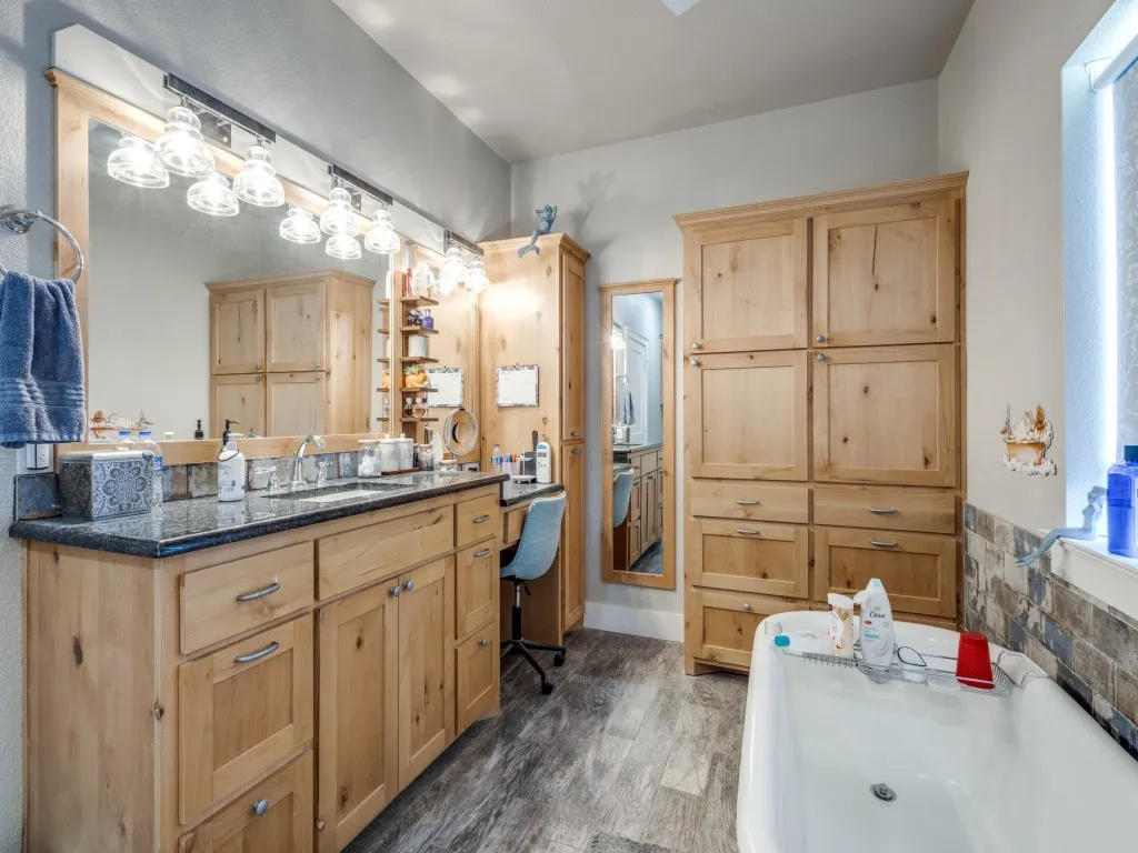 Bathroom featuring plenty of natural light, wood-type flooring, and vanity
