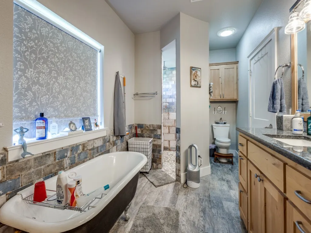 Bathroom featuring tile walls, hardwood e floors, and vanity