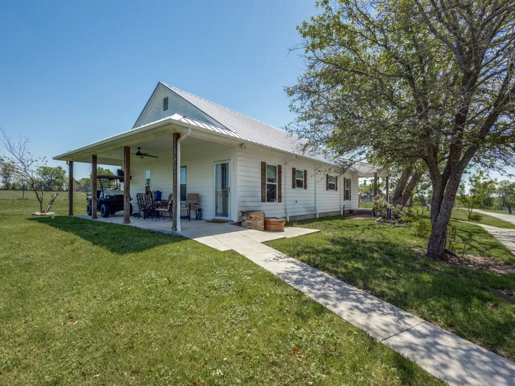 View of back of house with patio area and ceiling fan