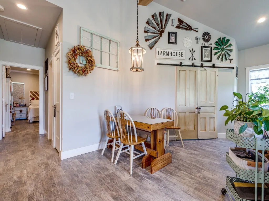 Dining area with light hardwood / wood-style floors and high vaulted ceiling