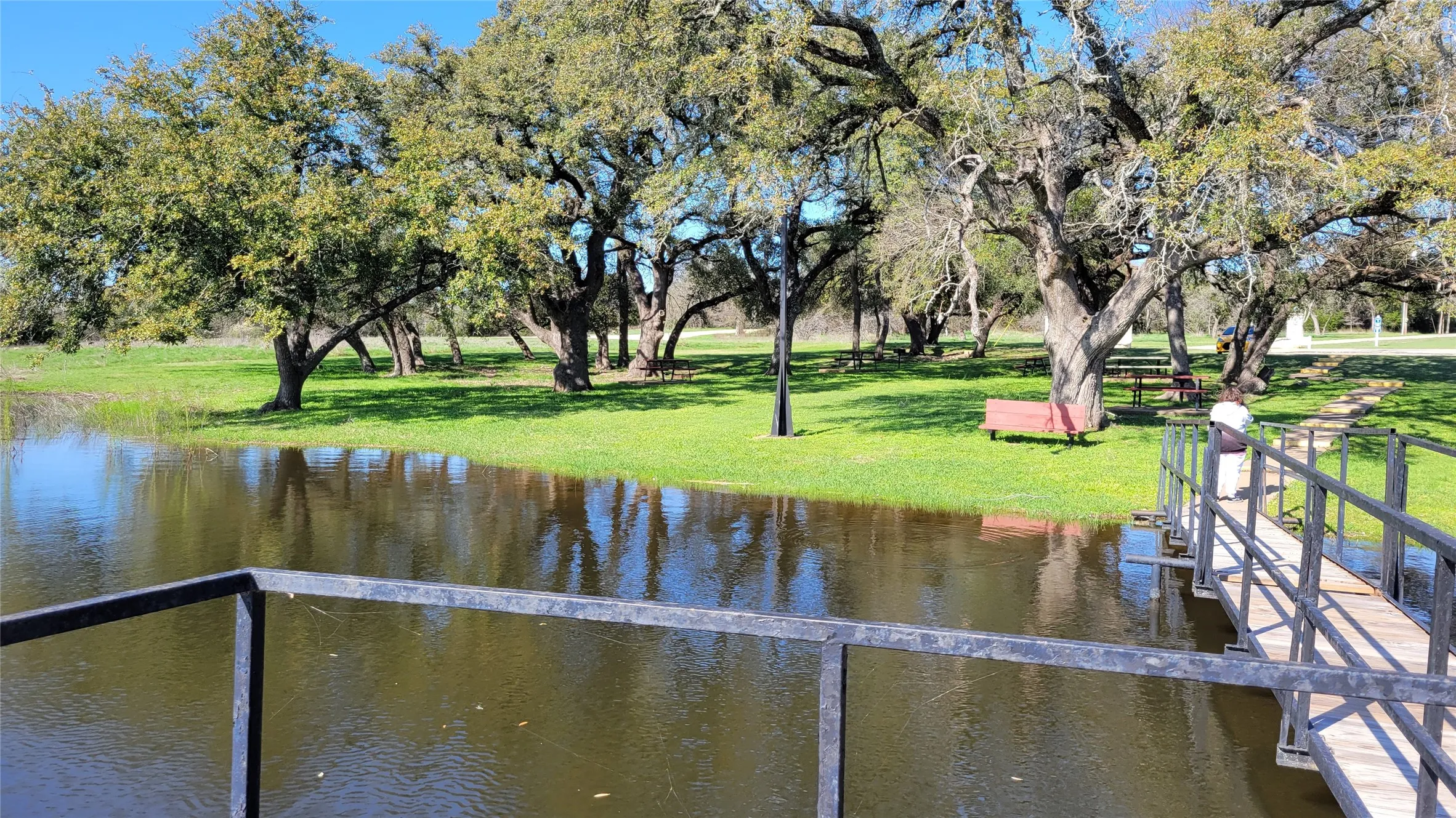 Dock area with a lawn and a water view