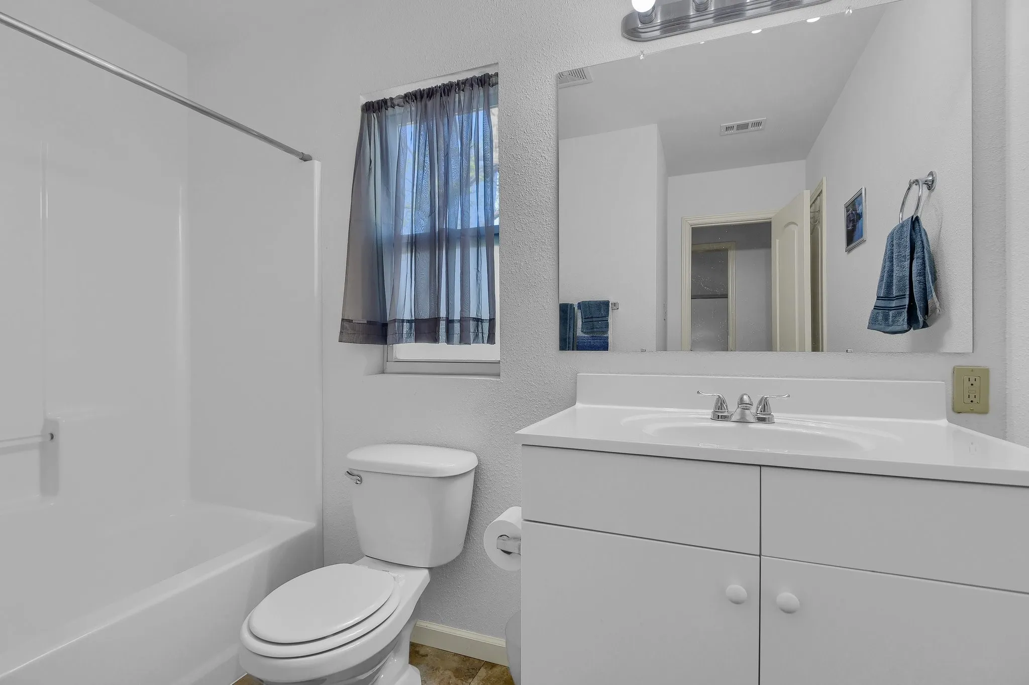 Full bathroom with  shower combination, toilet, and large vanity