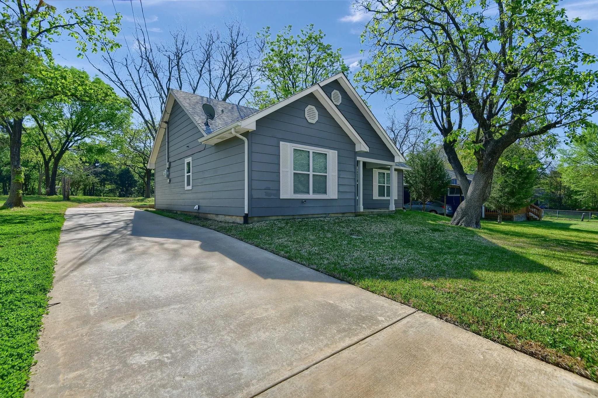View of side of property with a yard