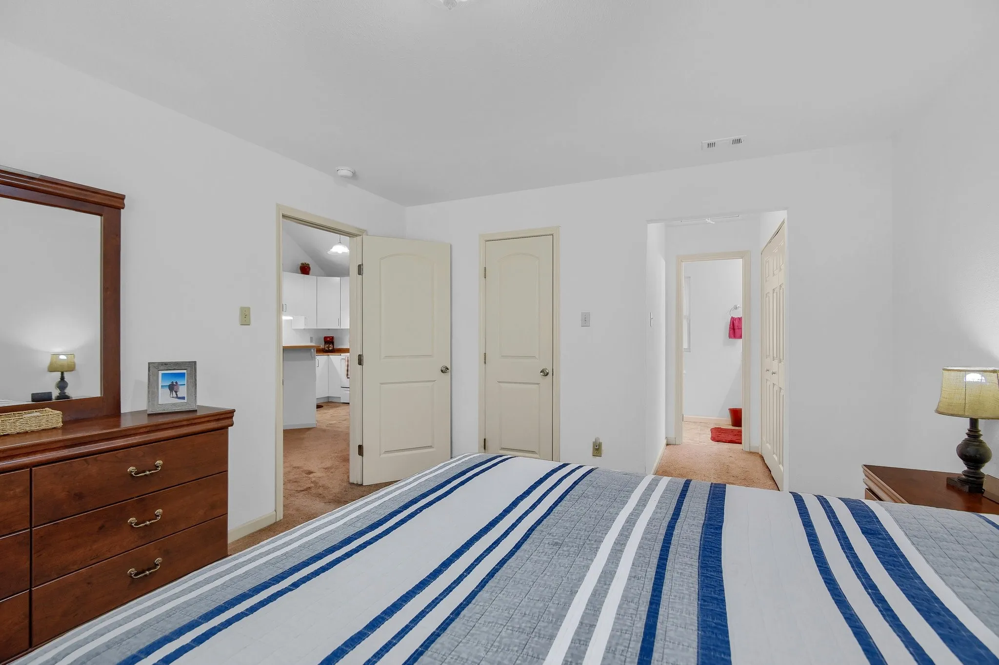 Carpeted bedroom with a closet