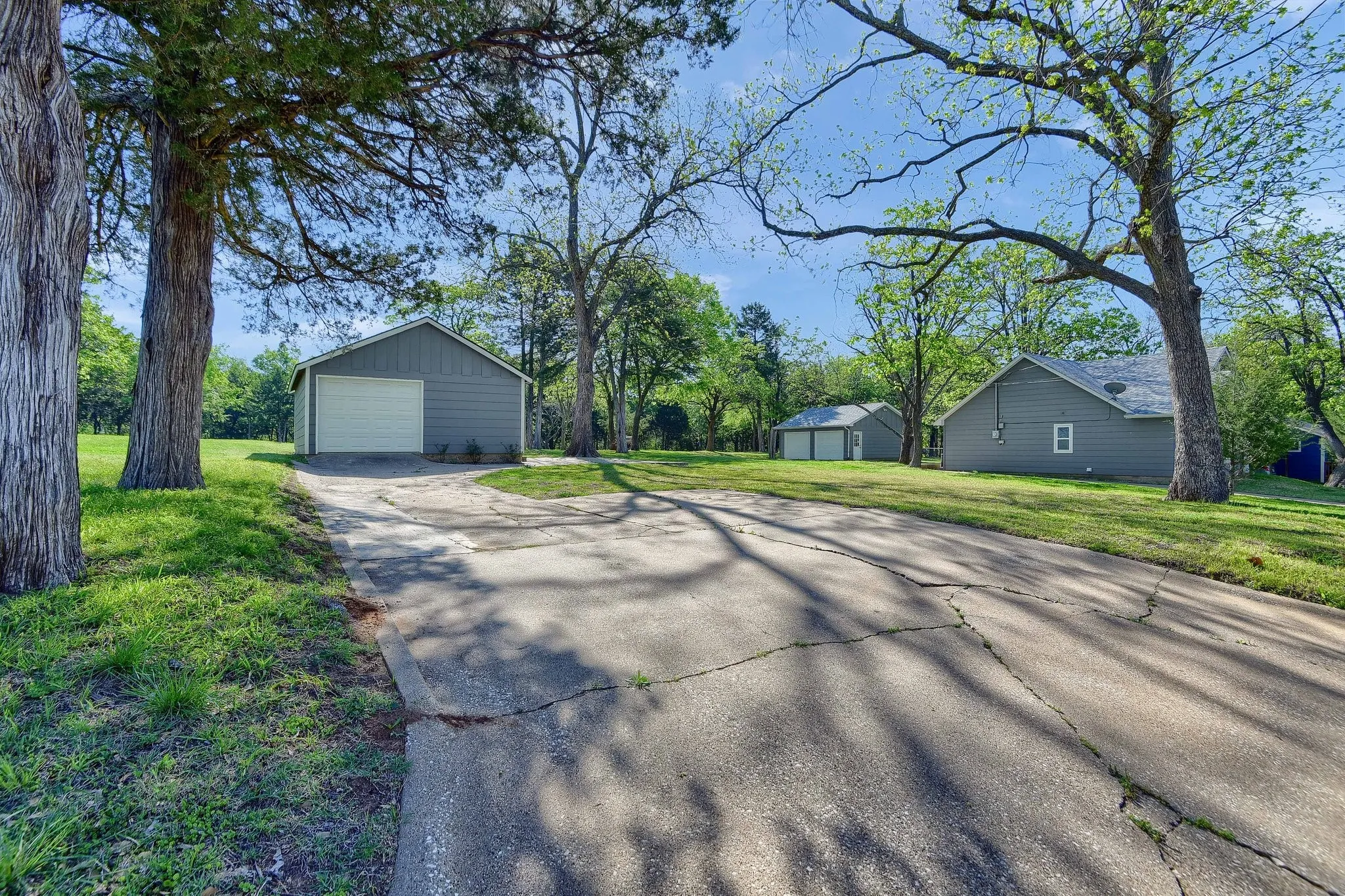Ranch-style home with a front lawn, an outdoor structure, and a garage