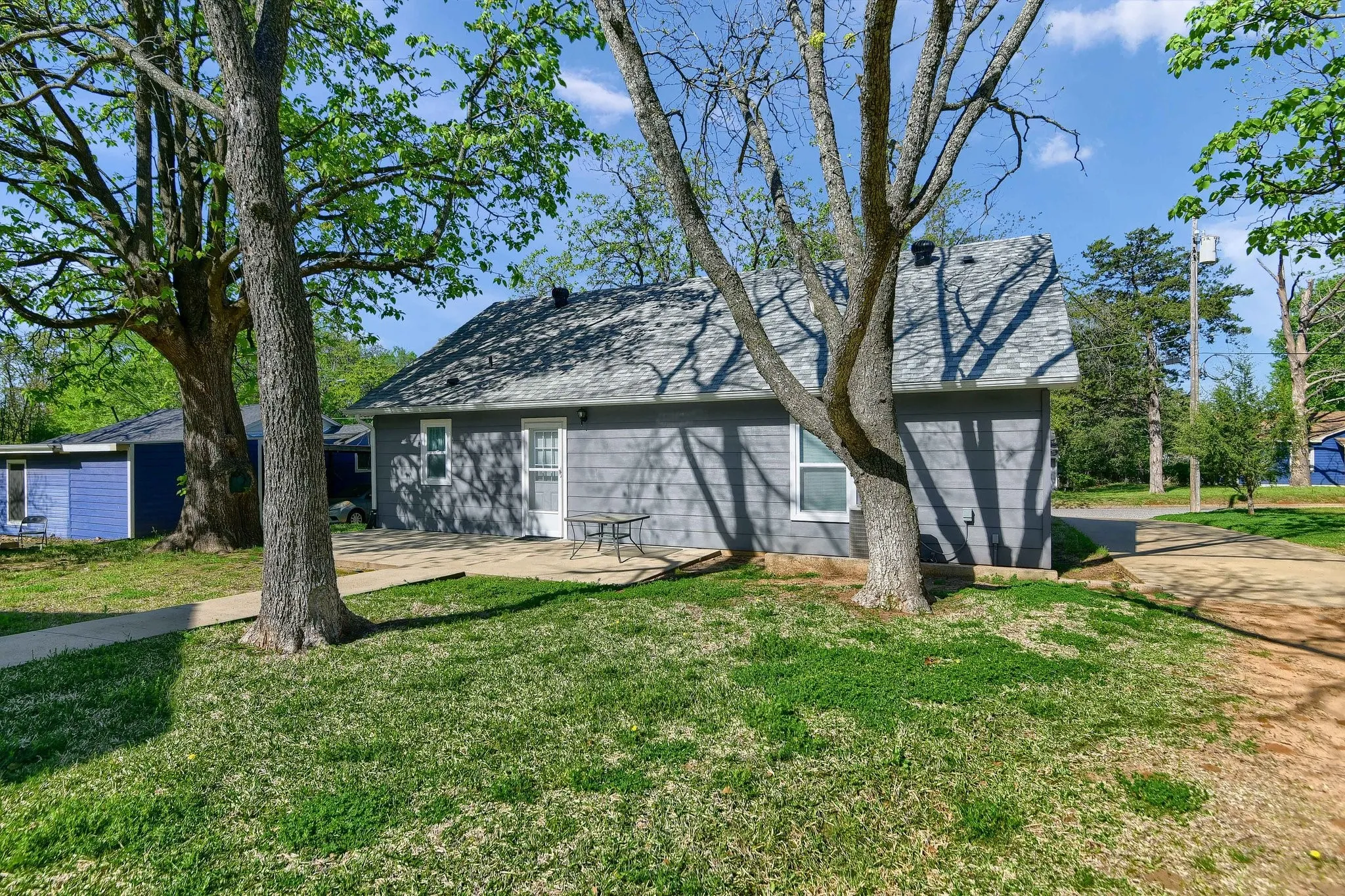 Back of property with a yard and a patio area