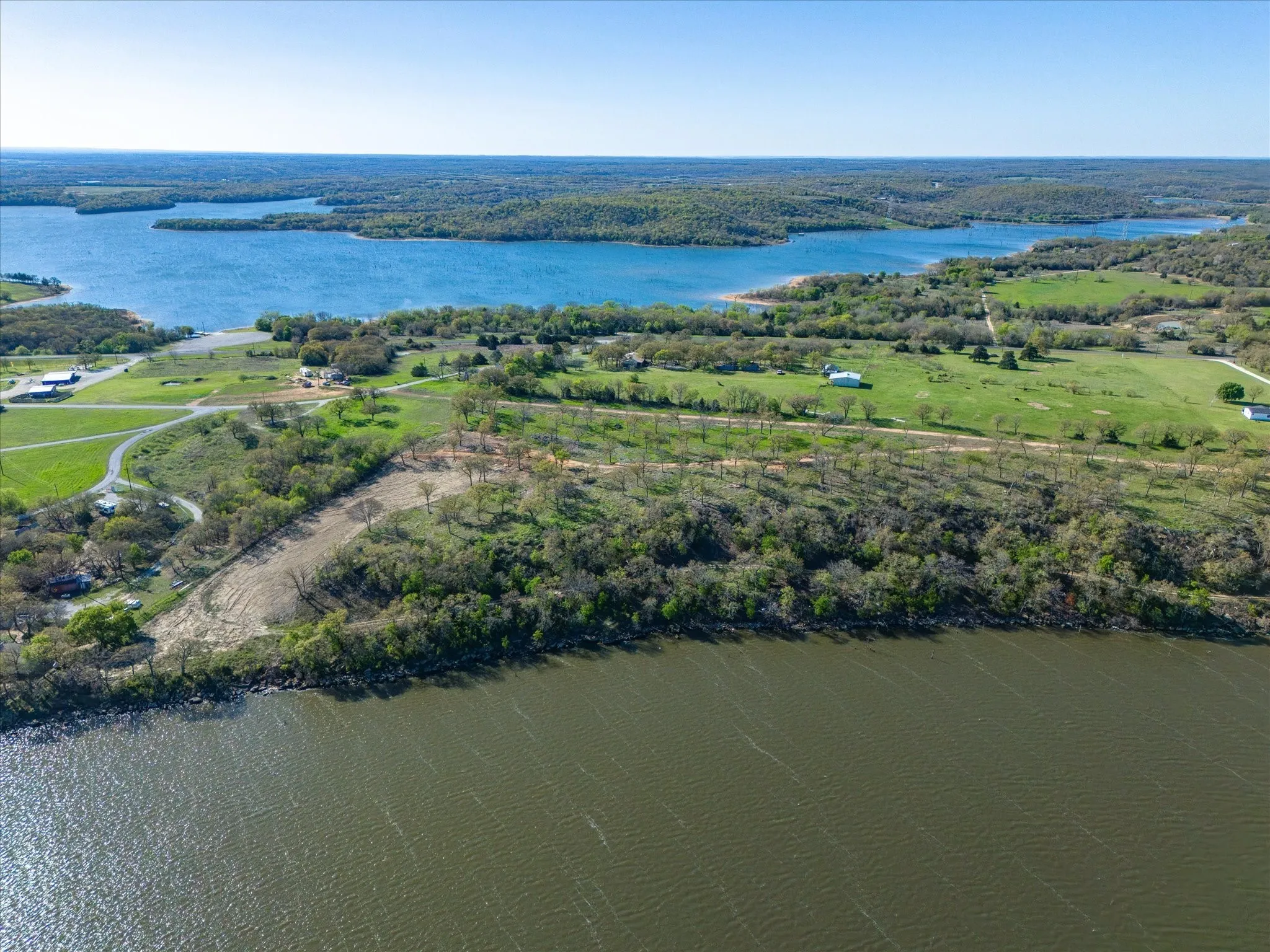 Birds eye view of property with a water view