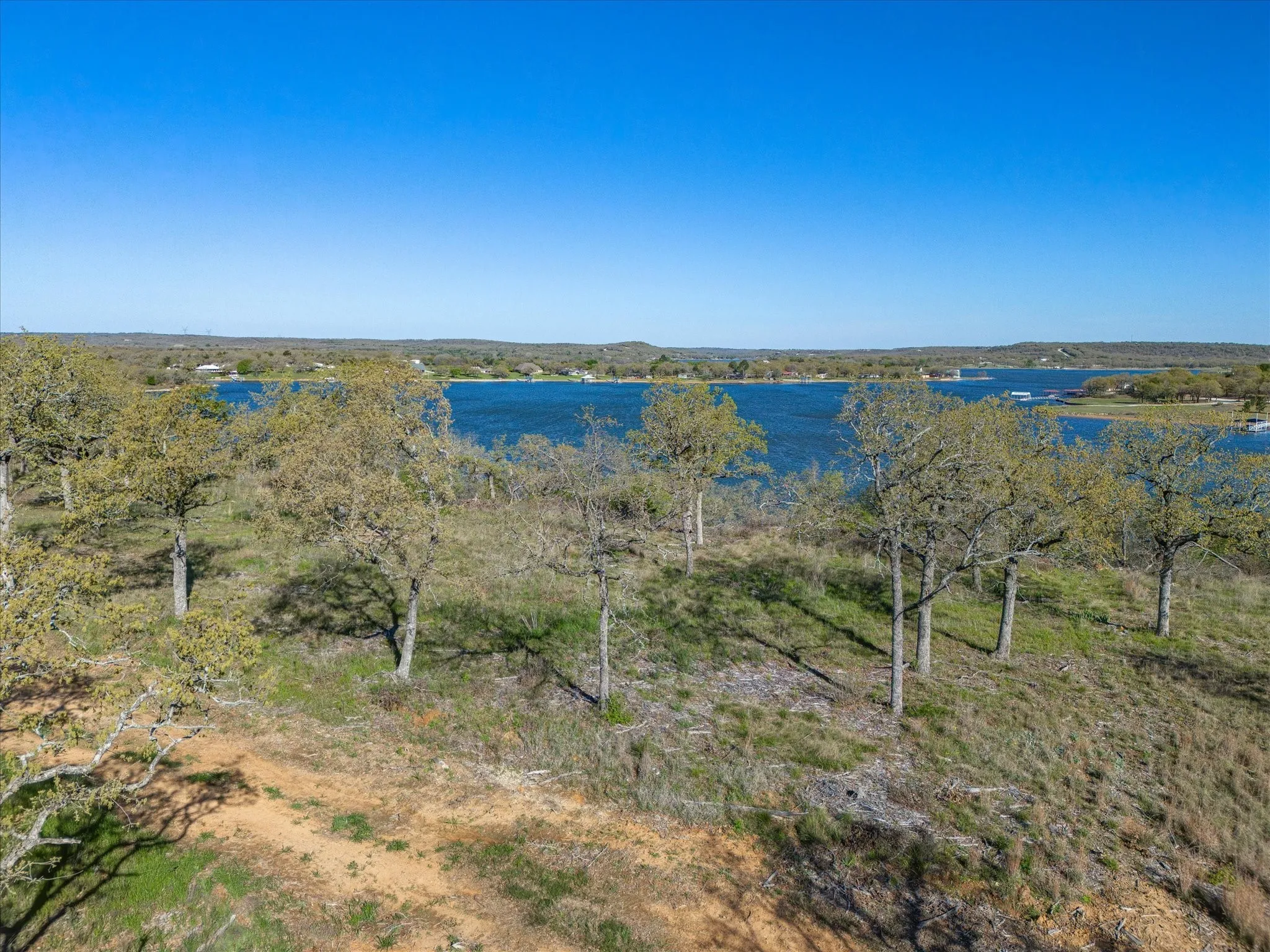 Birds eye view of property with a water view