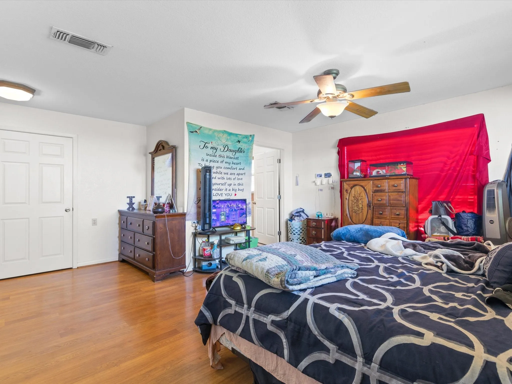 Bedroom featuring ceiling fan and dark wood-type flooring