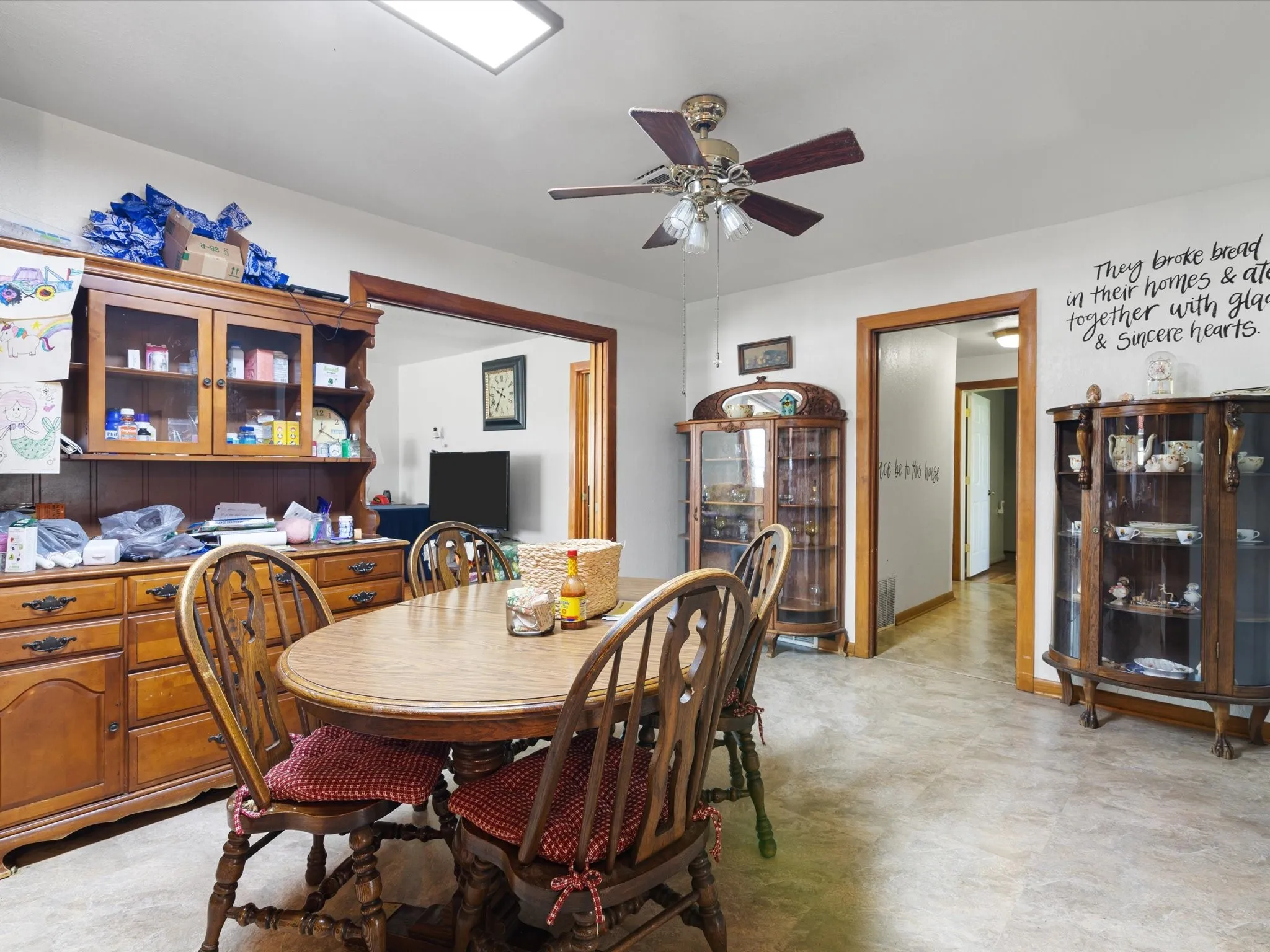 Tiled dining area featuring ceiling fan