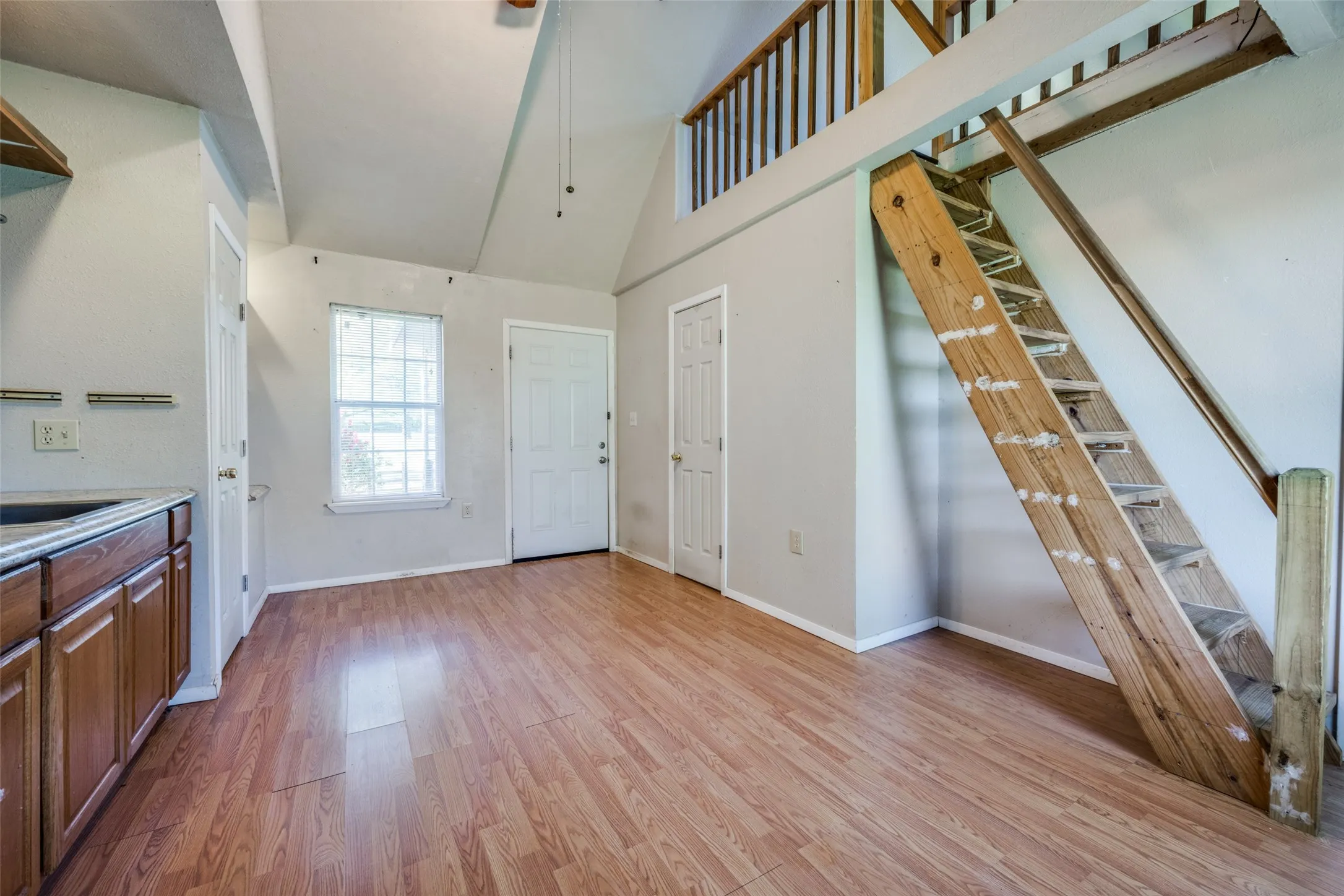 The versatile living area in the cottage has a sink & counter space for coffee and a microwave.  The stairs lead to a cozy loft.