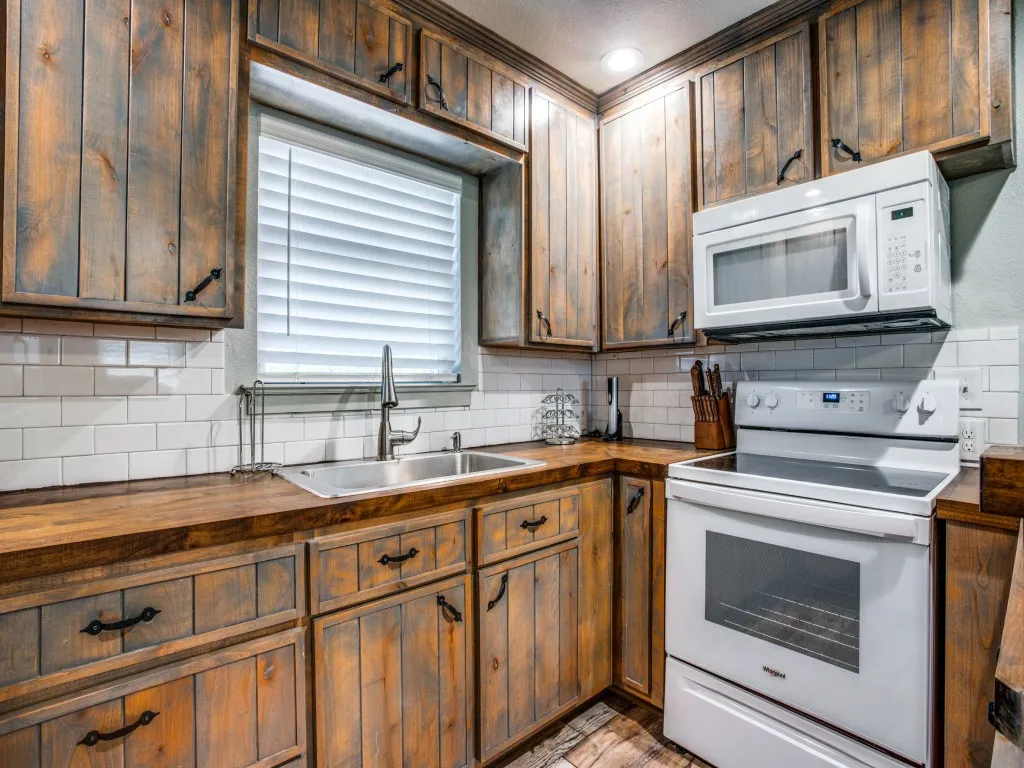 Second living quarters kitchen featuring hardwood / wood-style flooring, pendant lighting, a wealth of natural light